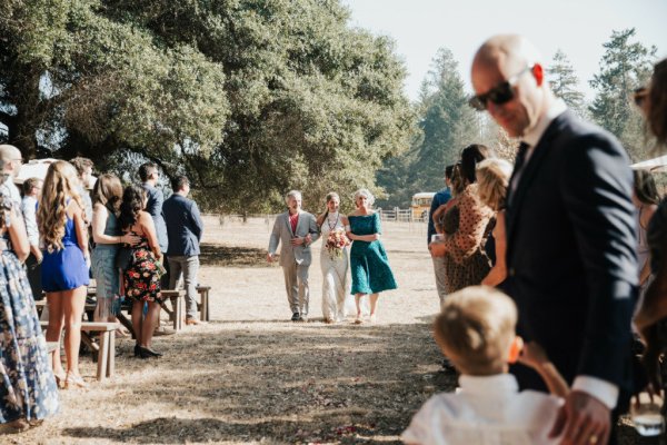 Mother father walk bride down the aisle guests wedding