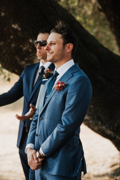 Groom and groomsmen wait for bride at aisle wedding