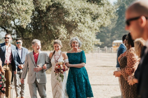 Mother father walk bride down the aisle guests wedding