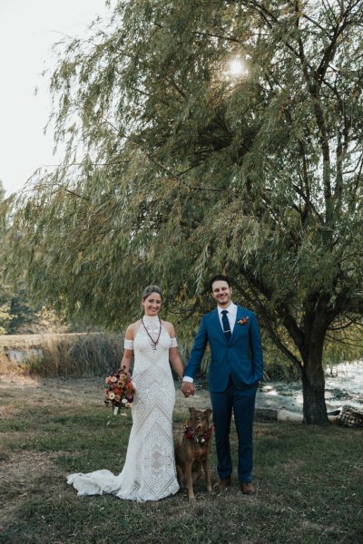 Bride petting horse bouquet and flowers groom