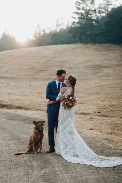 Bride and groom embracing flowers rose bouquet park forest