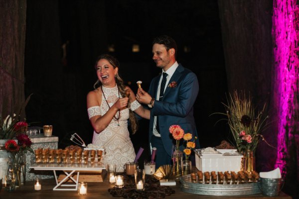 Bride and groom cut eat cake