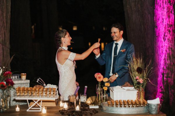 Groom and bride cutting eating cake