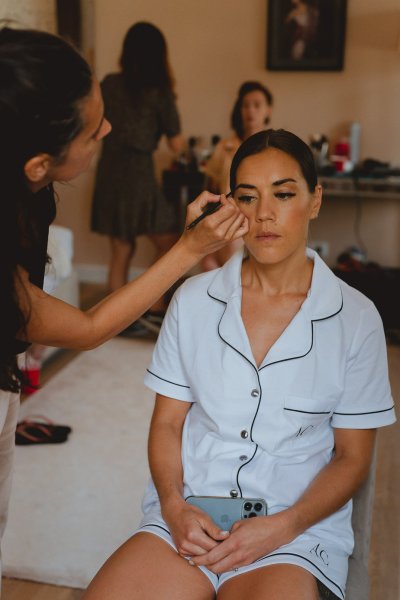 Bride getting ready hair MUA hairstyle earrings