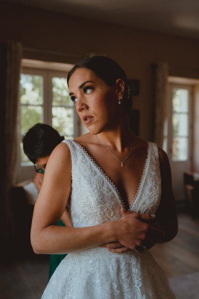 Bride getting ready wedding dress window