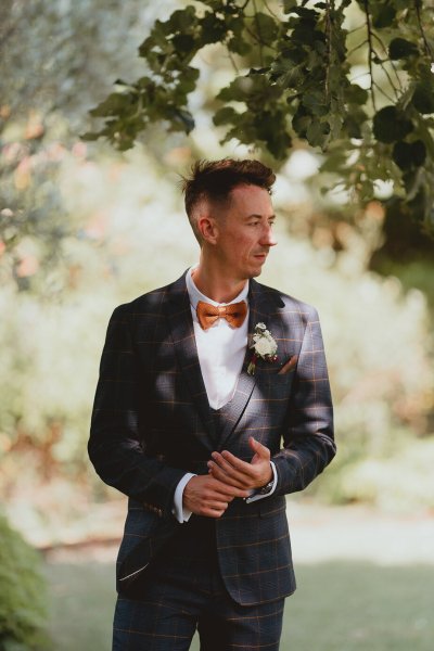 Groom awaits his bride at ceremony