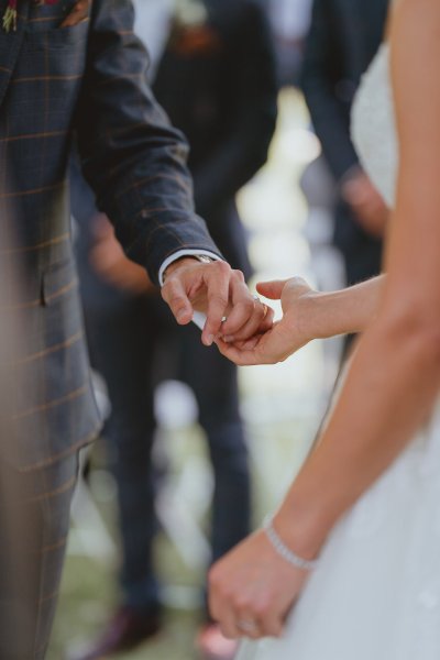 Bride and groom hold hands