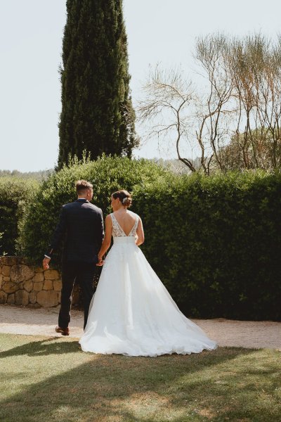 Bride and groom walking ceremony flowers