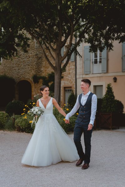 Bride groom outside bouquet of flowers sunshine