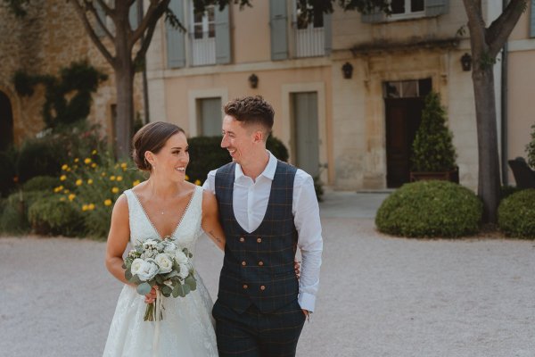 Bride groom outside bouquet of flowers sunshine