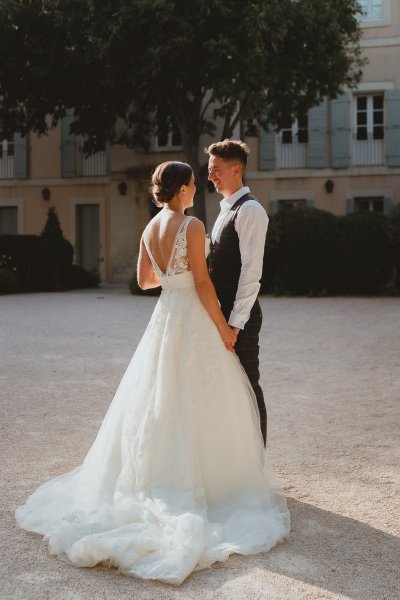 Bride groom outside bouquet of flowers sunshine