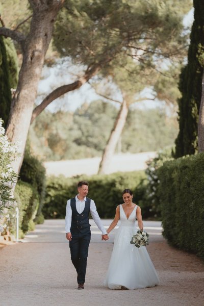 Bride and groom walking chateau