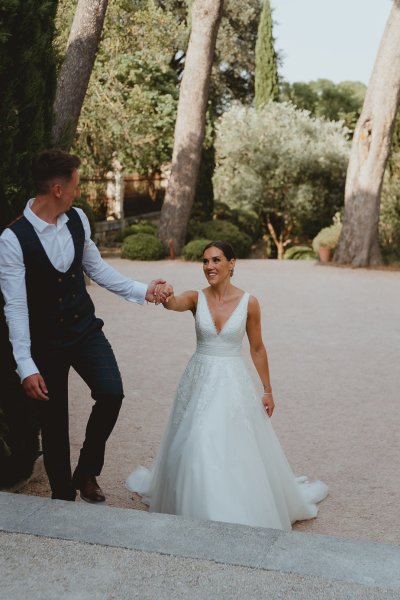 Bride and groom walking chateau