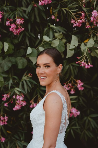 Bride in front of pink flowers dress