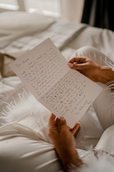 Bride pajamas reading letter bed bedroom