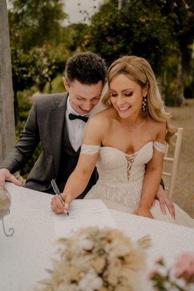 ceremony reading Bride and groom signing paper wedding