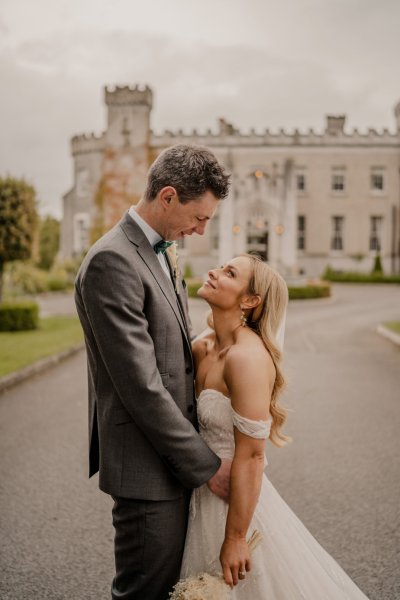 Couple after wedding ceremony bride groom bouquet flowers manor castle in background