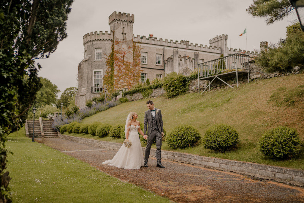 Couple after wedding ceremony bride groom bouquet flowers manor castle in background forest park