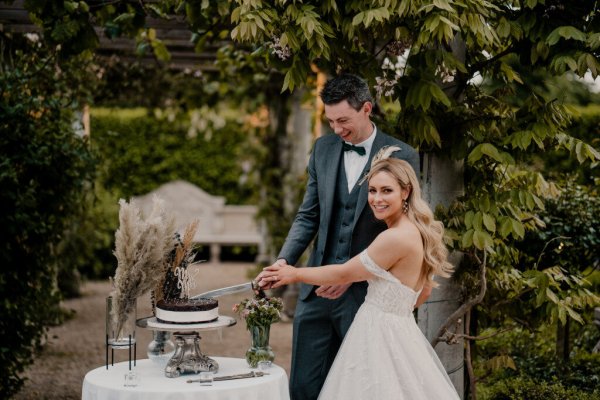 Bride and groom cutting chocolate cake