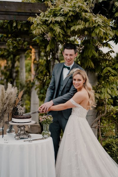 Bride and groom cutting chocolate cake