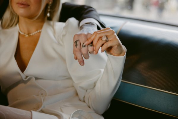 Couple holding hands touching tattoos ring nail detail