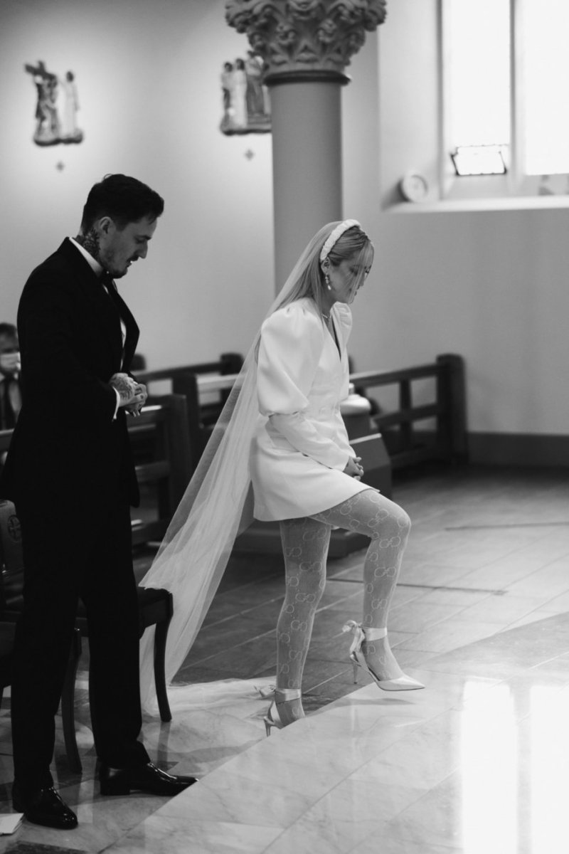 Bride and groom walking up the steps to priest