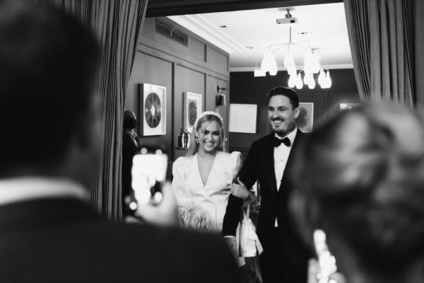 Bride and groom in venue chandelier in background