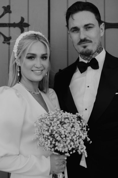 Wedding couple outside church venue short wedding dress bride and groom close up flowers bouquet