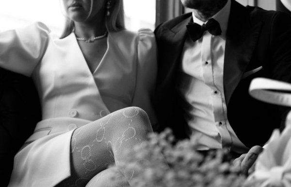 Bride and grooms legs close up and flowers