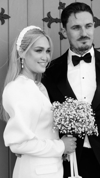 Wedding couple outside church venue short wedding dress bride and groom close up flowers bouquet