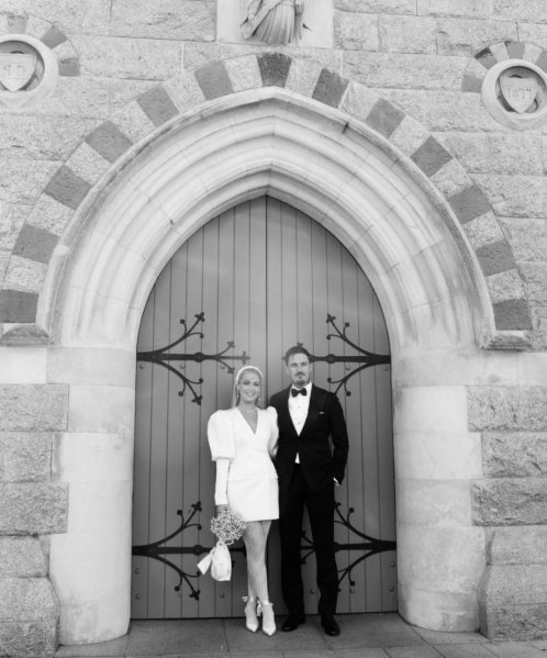 Wedding couple outside church venue short wedding dress bride and groom