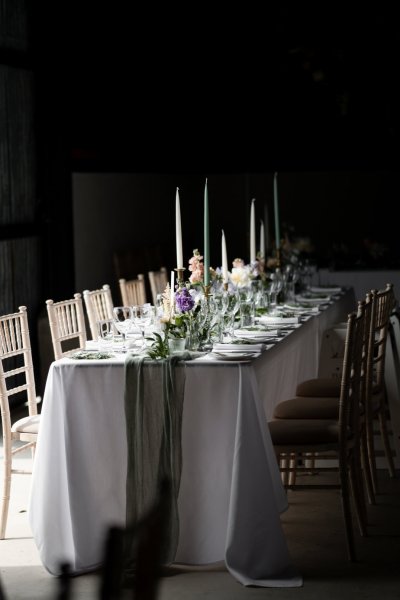 Empty dining room tables chairs flowers candles