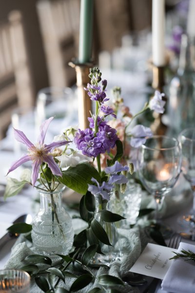 Table in dining room with flowers and cutlery