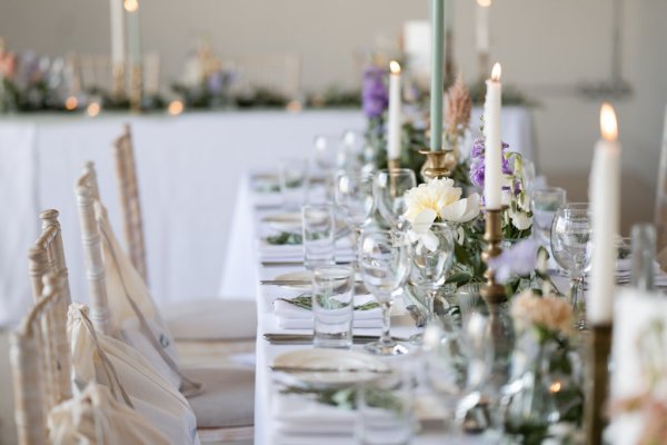 Empty dining room table with candles white roses