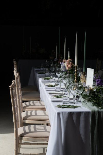 Empty dining room tables chairs flowers candles