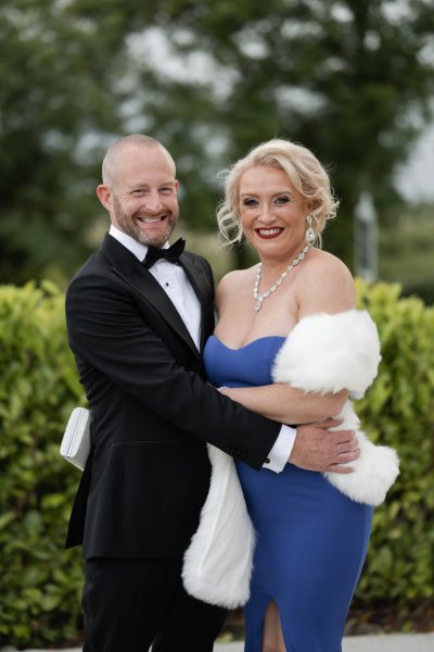 Groom and bridesmaid sister smiling