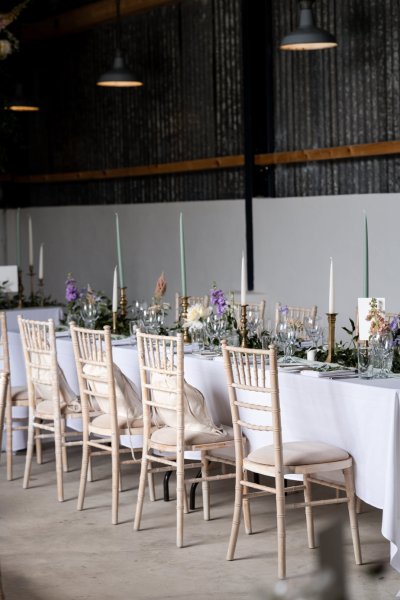 Empty dining room tables chairs flowers candles