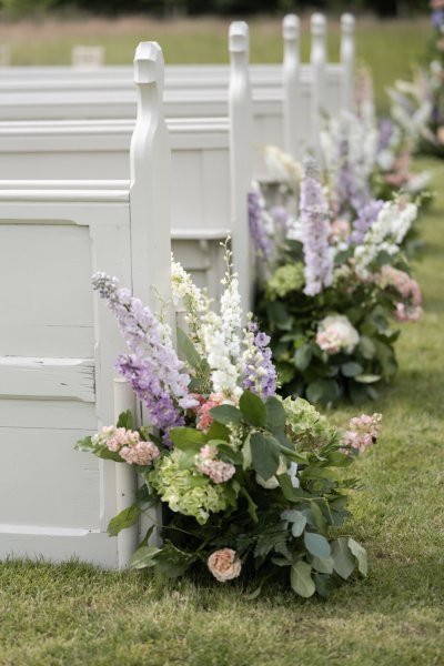 Flowers beside the seats for wedding ceremony roses