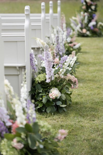 Flowers beside the seats for wedding ceremony roses