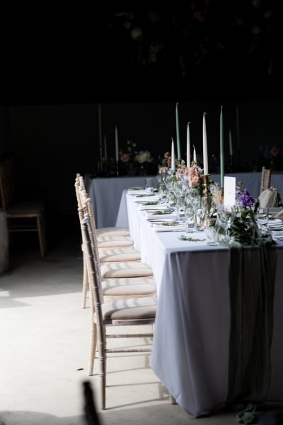 Empty dining room tables chairs flowers candles