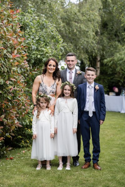 Family and children in garden with flowers in background