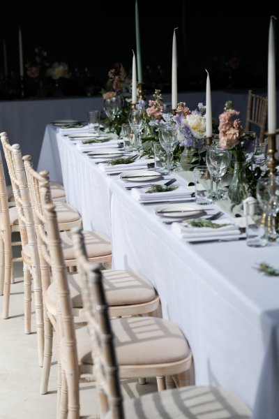 Empty dining room tables chairs flowers candles