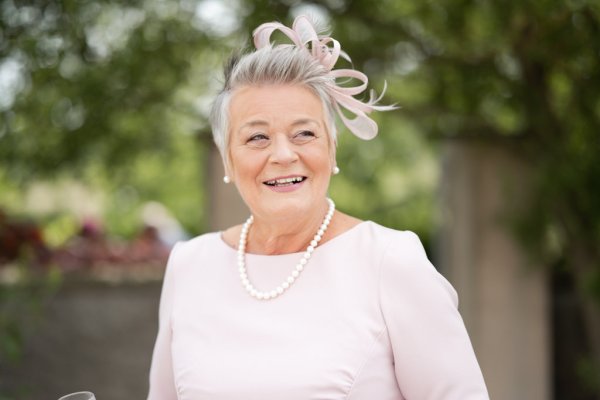 Mother woman wearing pink bow smiling