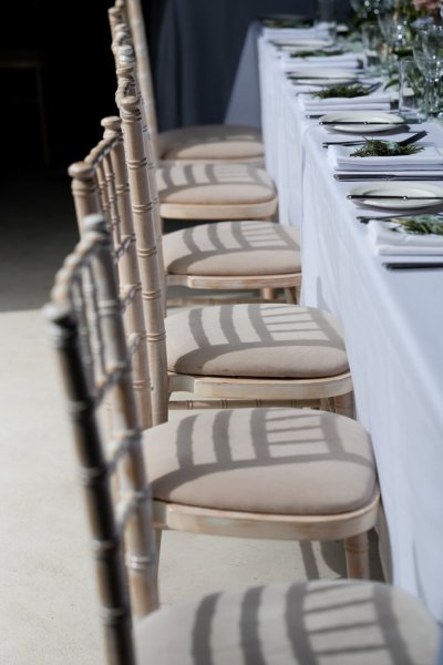 Empty dining room tables chairs flowers candles