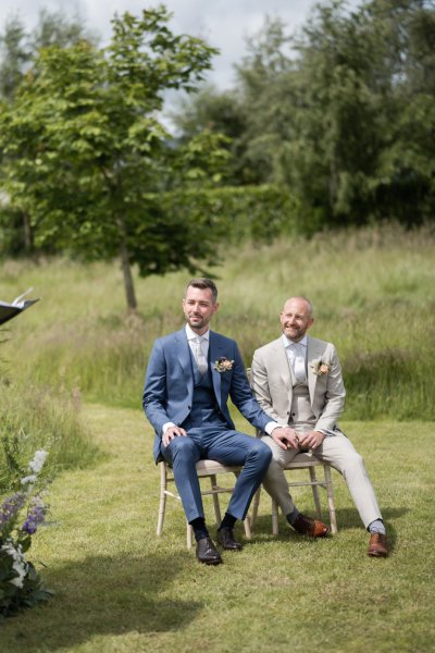 Groom and groom sitting down during wedding ceremony