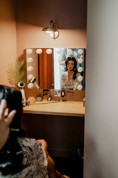 Bride looking in mirror reflection