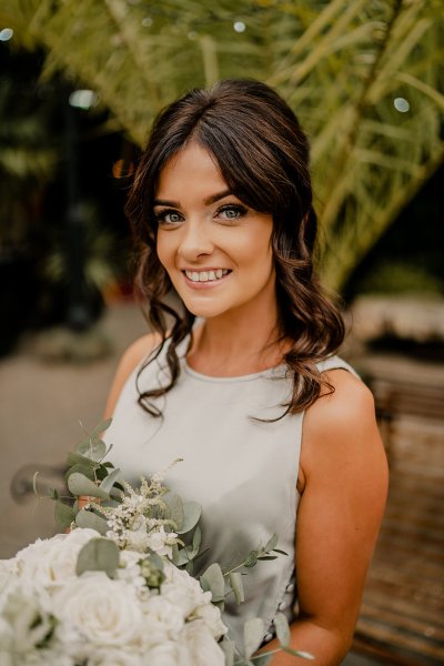 Bridesmaid wearing satin gown smiling