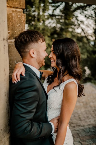 Bride and groom look at each other smile