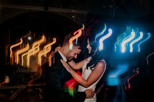 Bride and groom dance on dancefloor