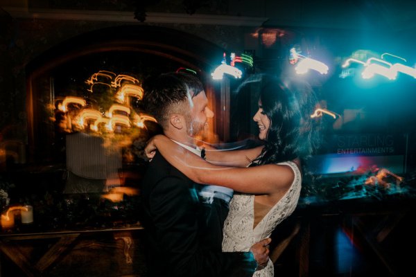 Bride and groom dance on dancefloor